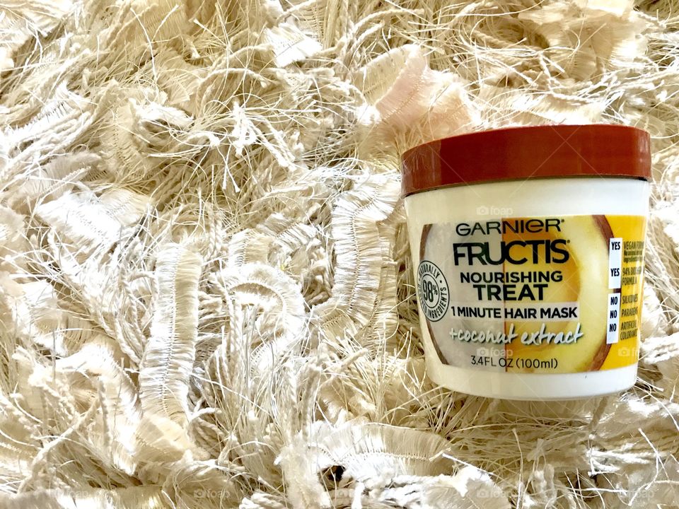 Fructis coconut hair mask flat lay with cream color textured background 