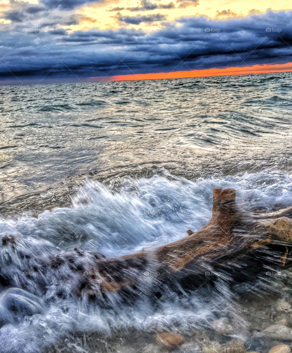 Wave splashing on driftwood