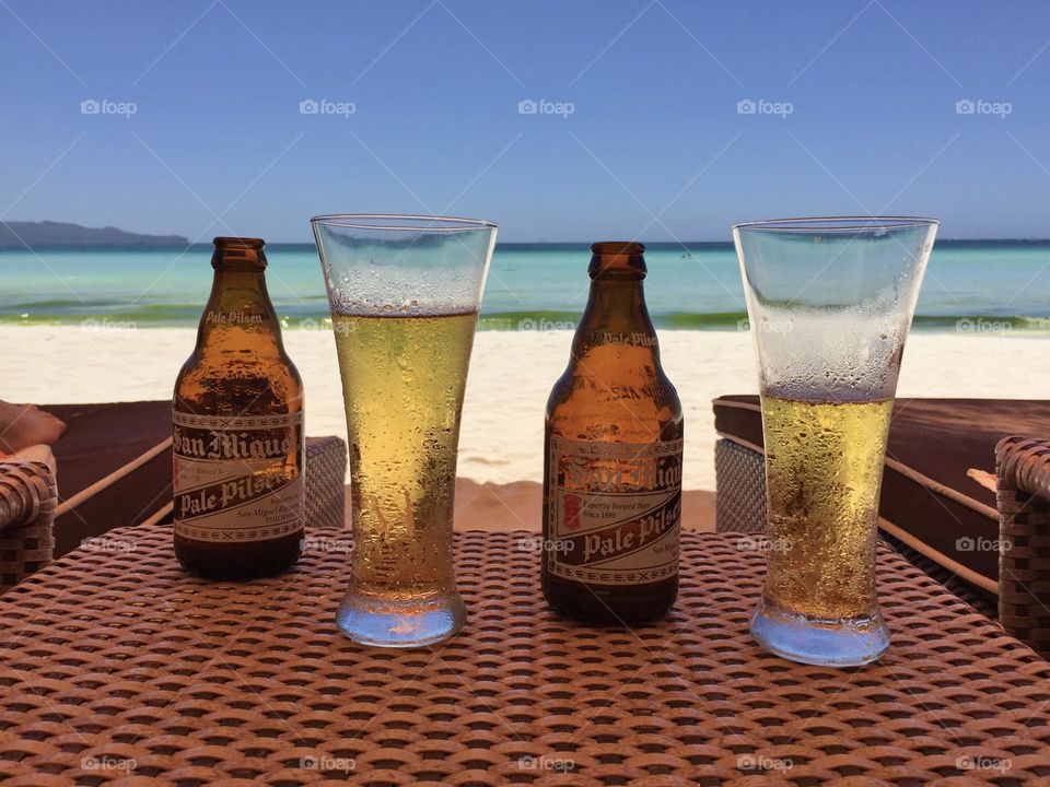 beer in deckchair on the beach