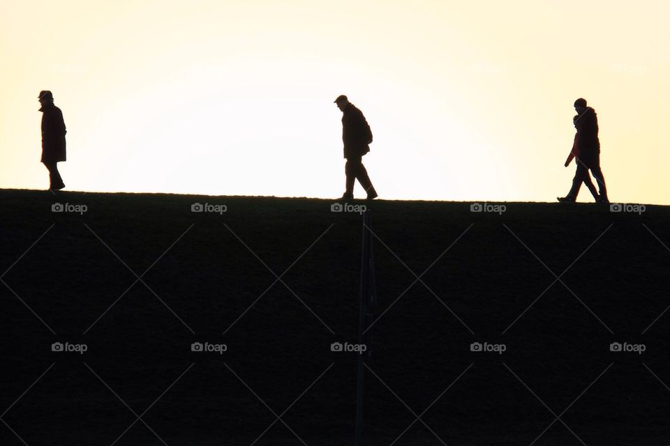 Silhouette of people walking