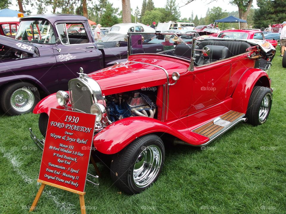 A classic bright red hot rod at the annual car show in Drake Park in Central Oregon during the summer. 