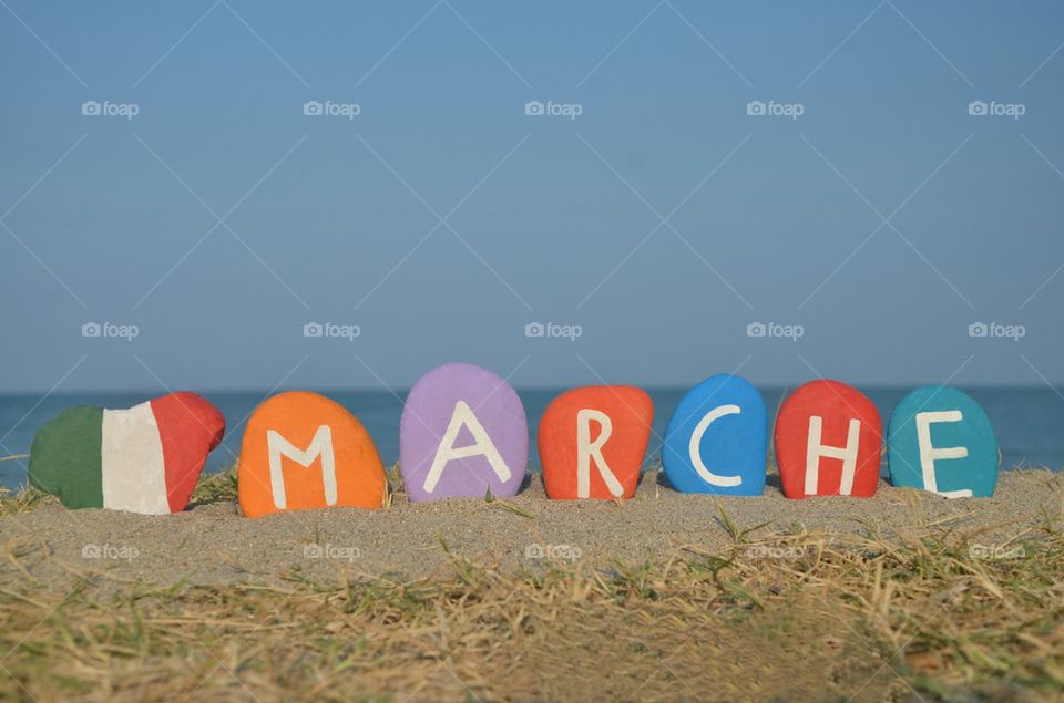 Souvenir on colourful stones of Marche region, Italy