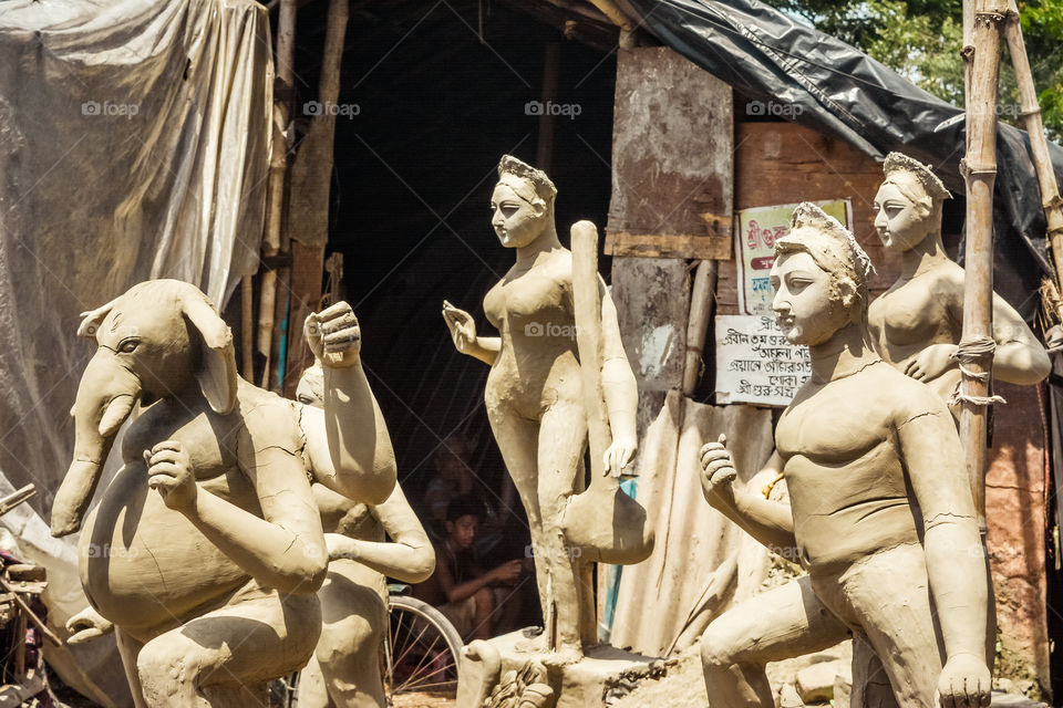 Unfinished Art model of Maa Durga. Goddess Durga sculpture made of clay during upcoming famous Durga Pooja Celebration. Taken from potter studio in Kumartuli, Calcutta Kolkata, West Bengal, India.