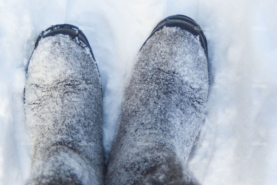 man in boots standing in the snow