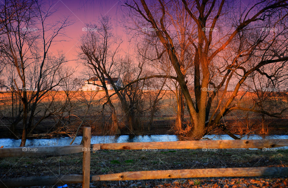 countryside sunset. stream along farmland at sunset