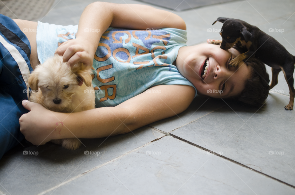 child playing with pets