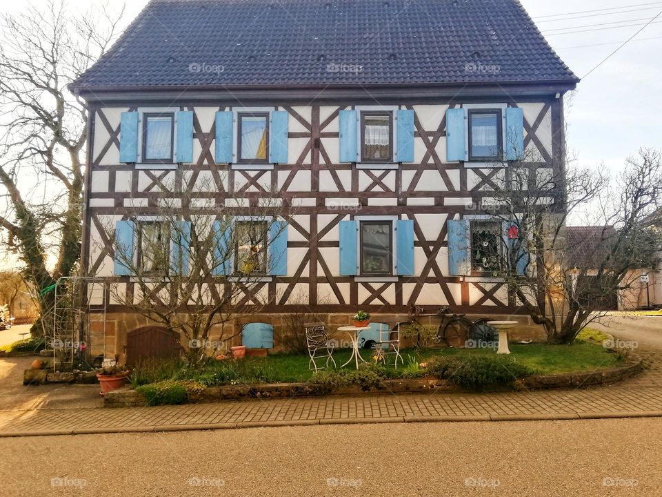 Old house with blue shutters. France.