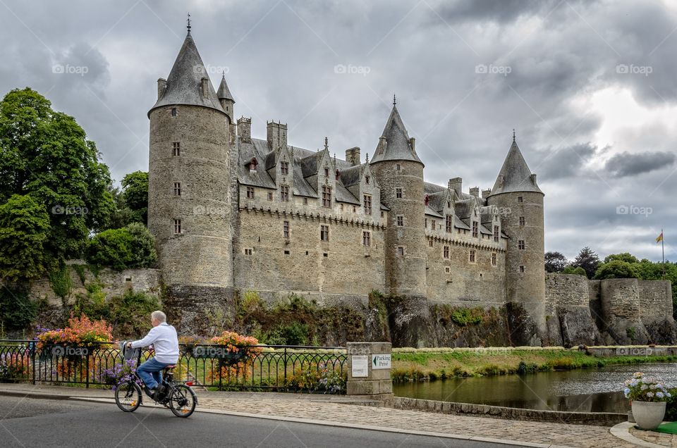 Man riding on a bike in front of the Castle 