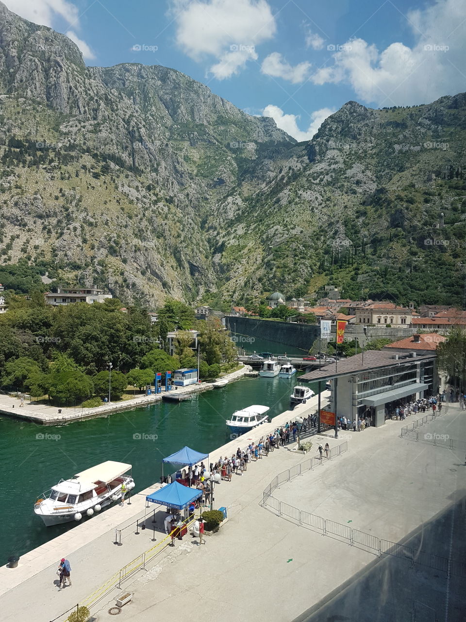 view from cruise ship balcony of Montenegro Port with beautiful green and rocky hills on summer vacation