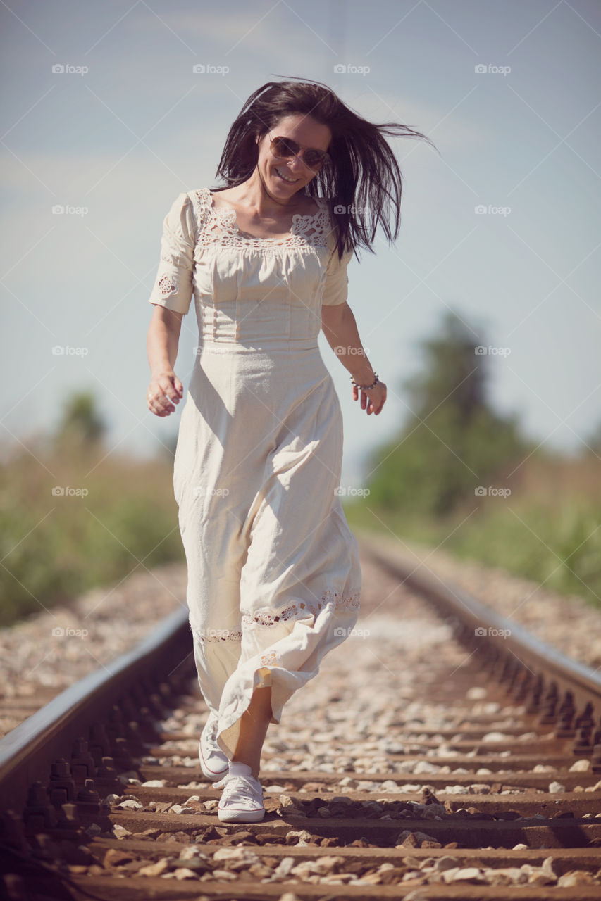 Woman running on railroad 