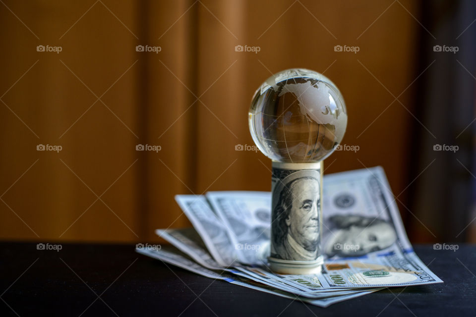 transparent globe on dollars