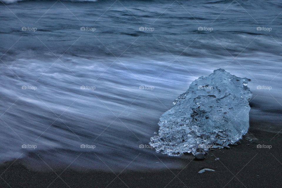 Ice on black sand at beach