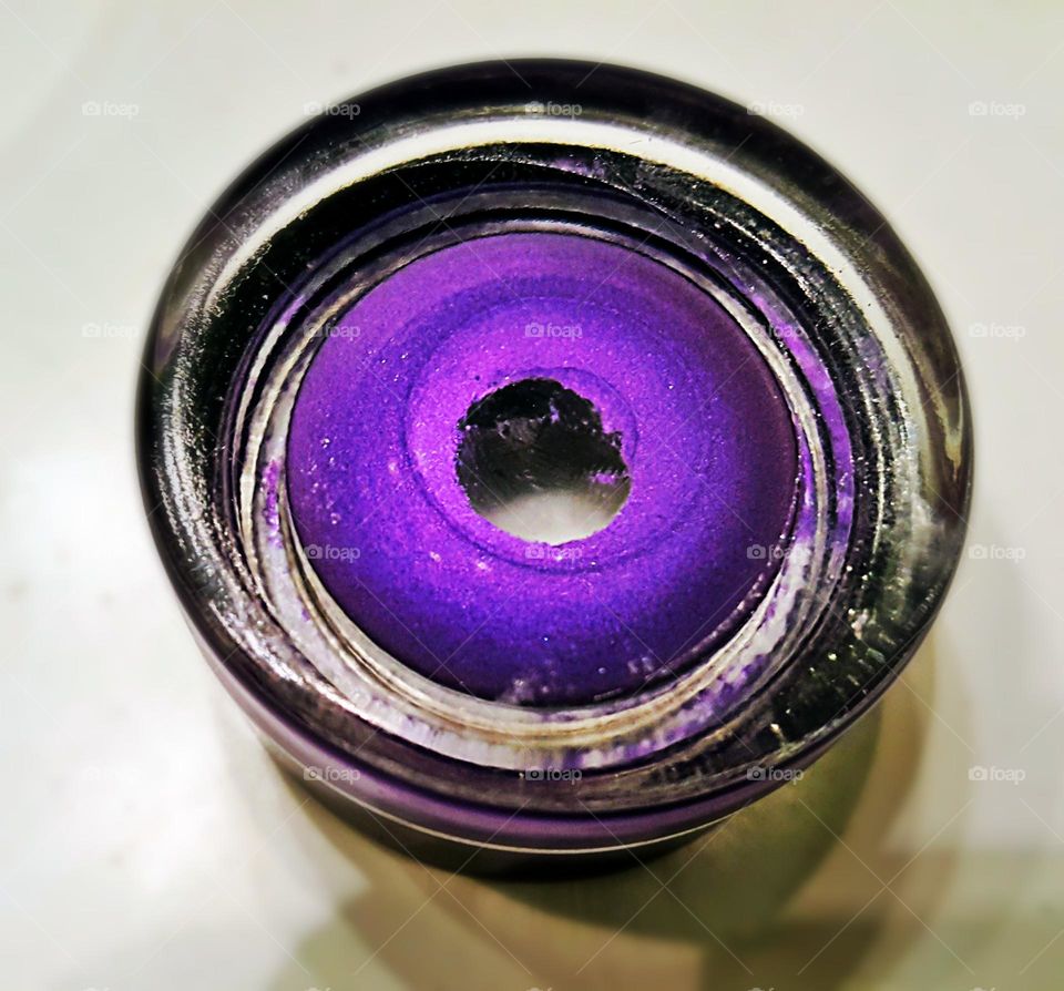Beautiful shades of purple that's swirled in a circular glass.