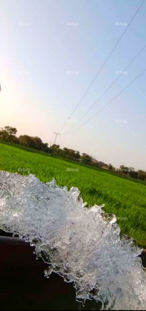 in character. tubewell water flow with a beautiful view