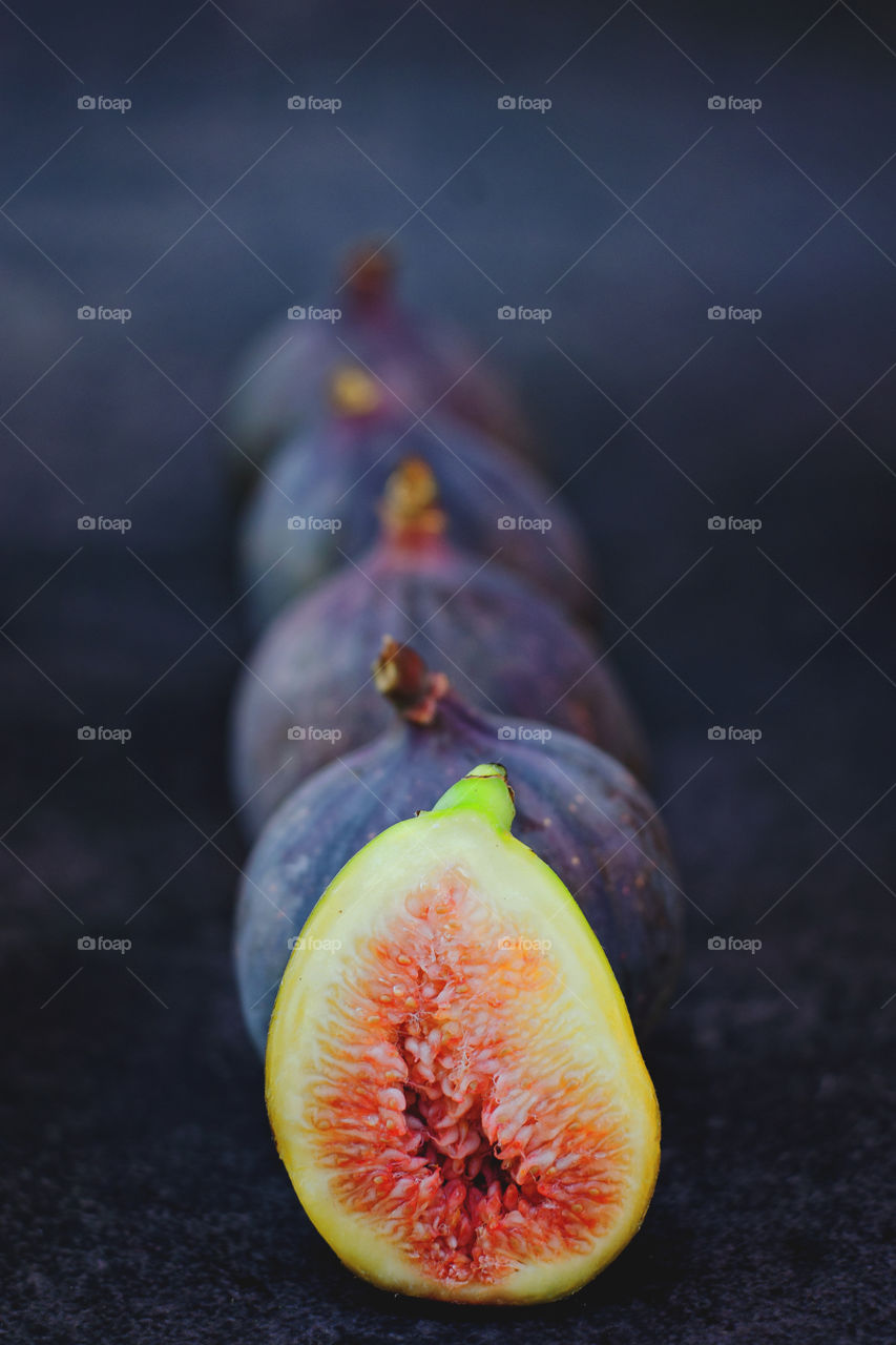 Background of the fresh ripe figs fruits in the dark background close up. Top view. Flatlay.