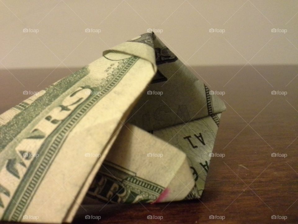 an arrow made out of a folded up twenty dollar bill