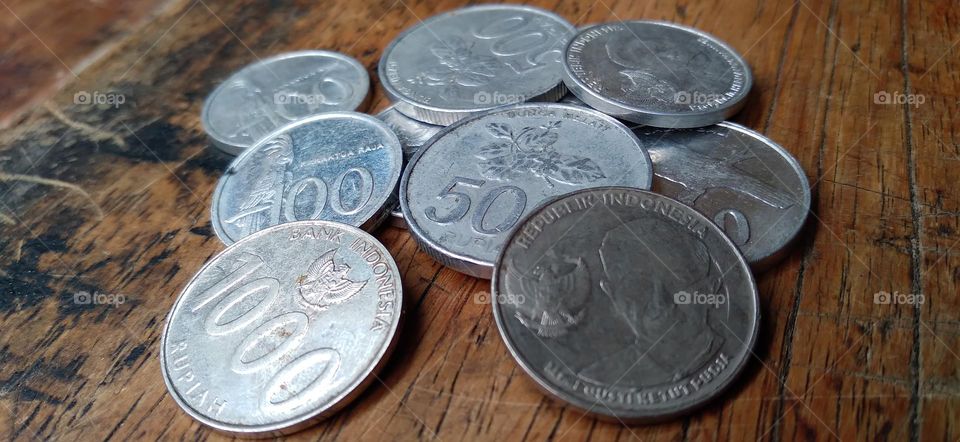 Rupiah coins on an ancient wooden table