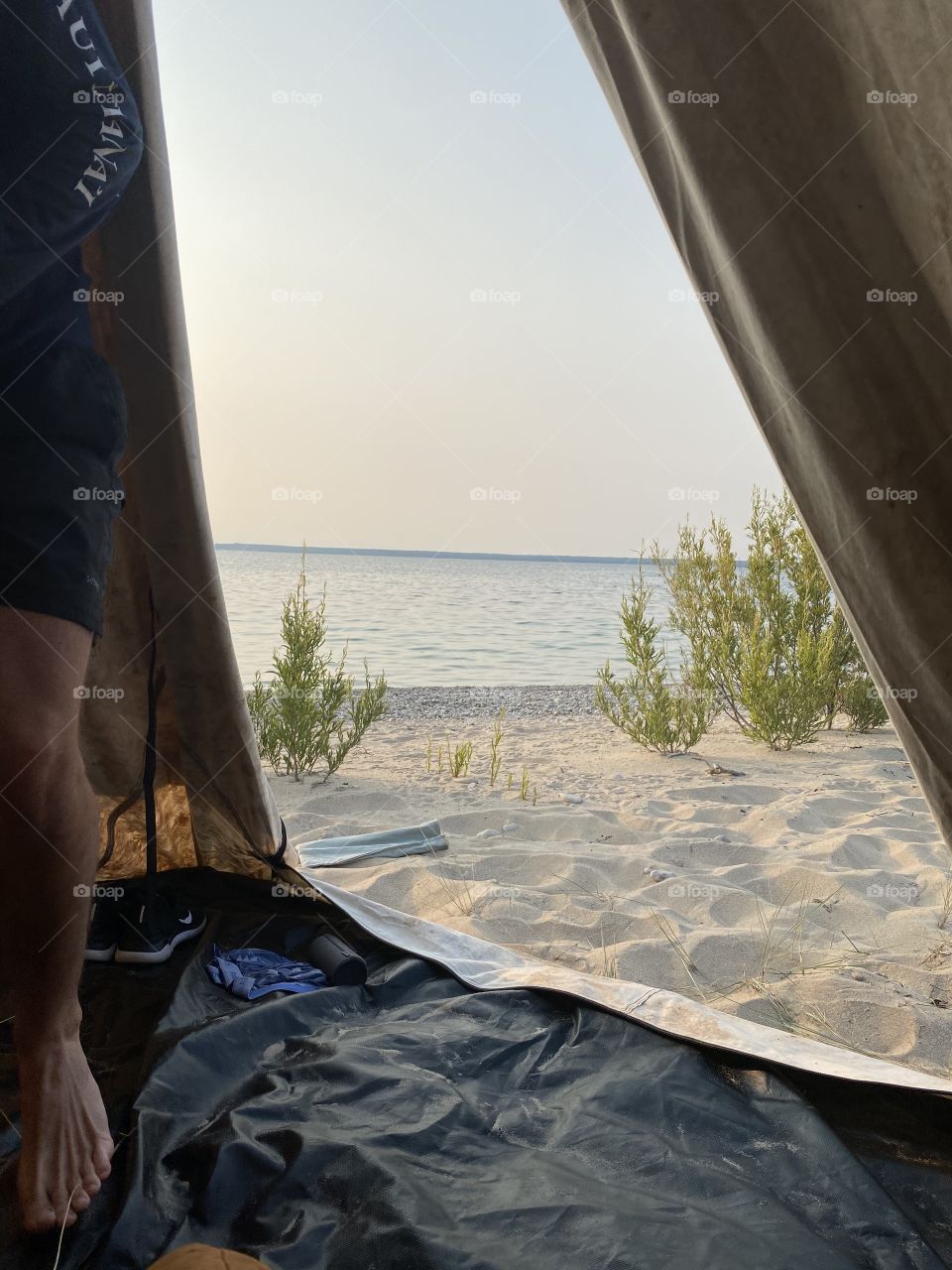 Peeking out of the tent to see the beautiful beach view.