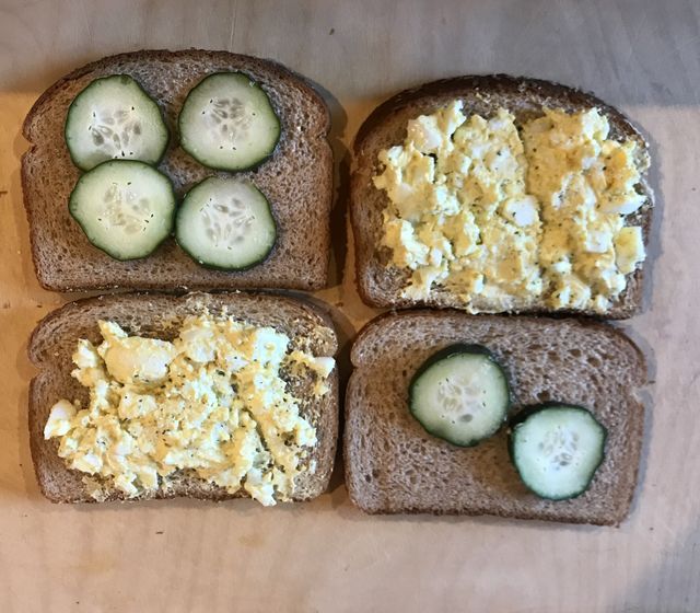 Egg salad sandwiches on a cutting board