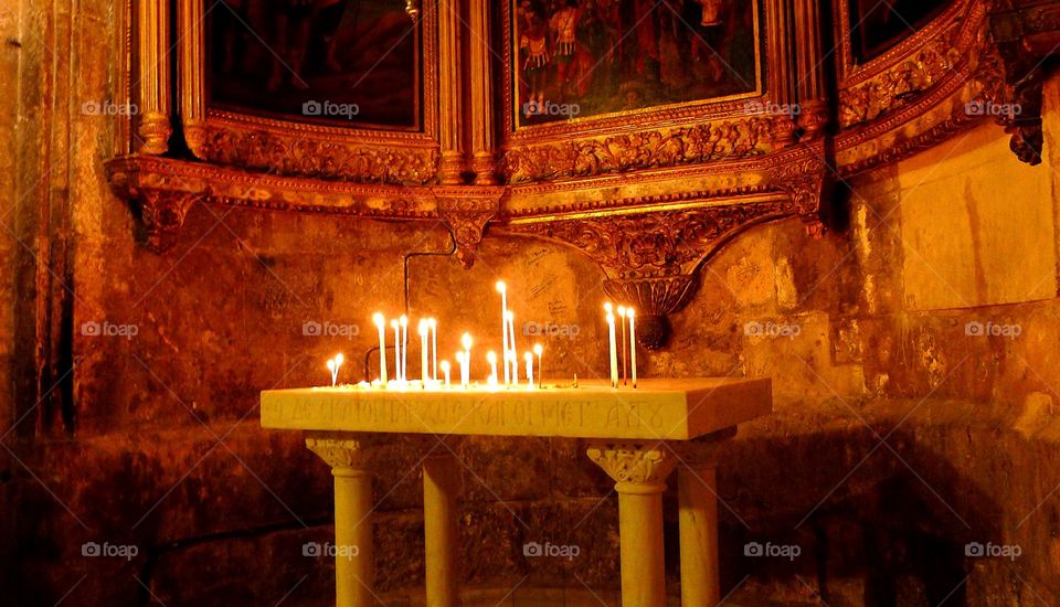 The Church of the Holy Sepulcher in the Old city of Jerusalem. With burning candles 