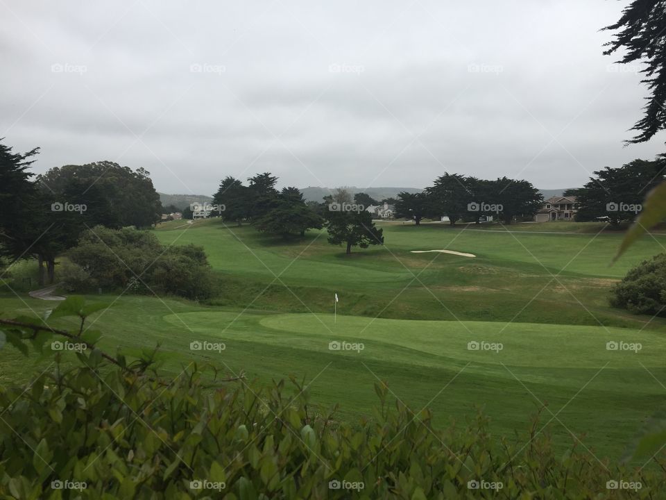 Golf course in Half Moon Bay under cloudy skies 