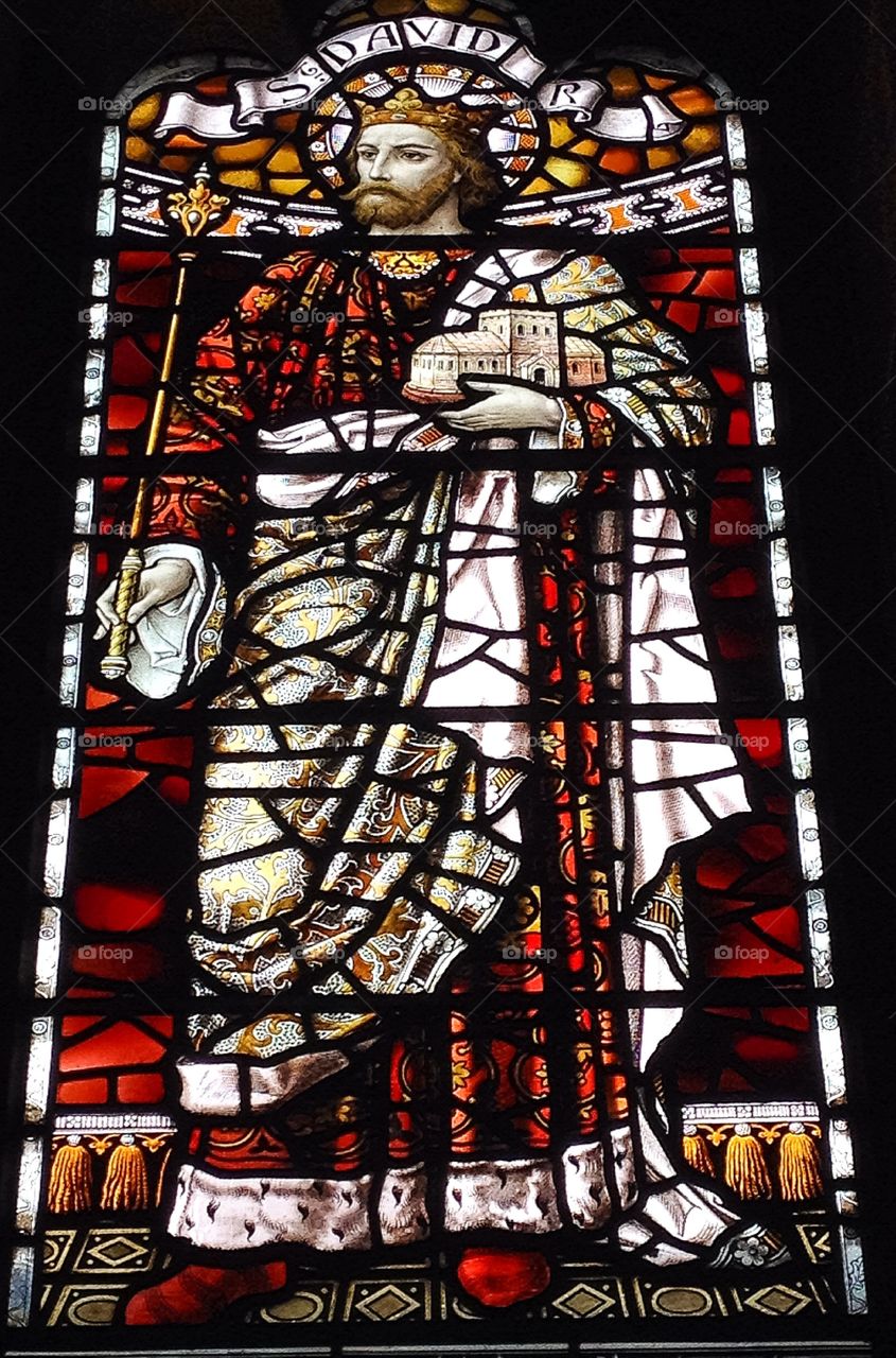 Saint David Stained Glass. A snap of a pane from a stained glass window. The panel above his head names him as St David, patron saint of Wales