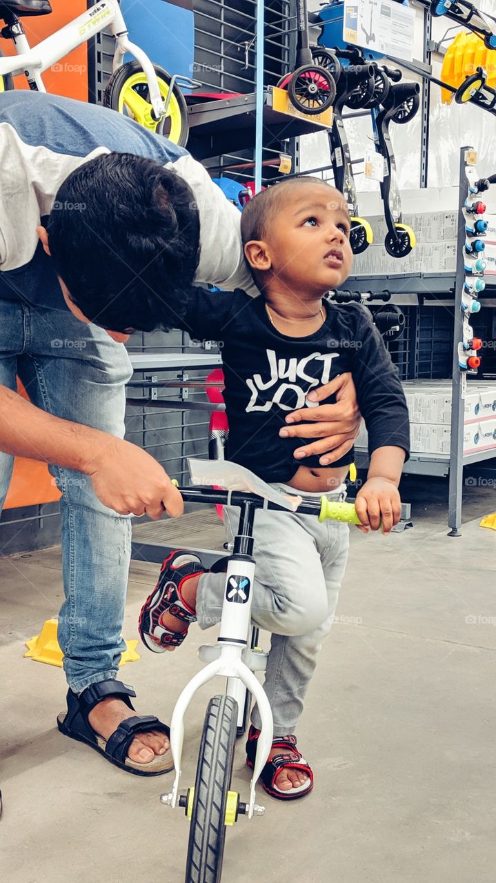 father excited to teaching child to ride bike