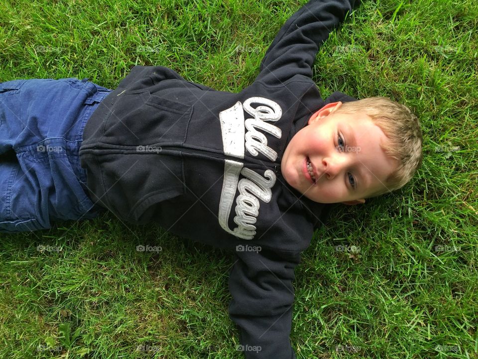 Laying in the grass . Mason relaxing 