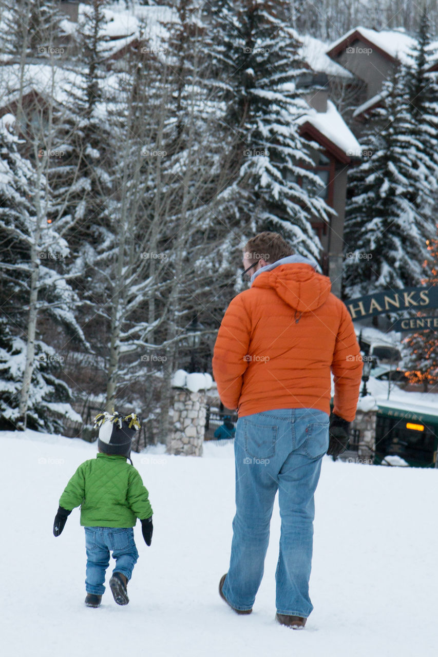 Father and son walking in the snow