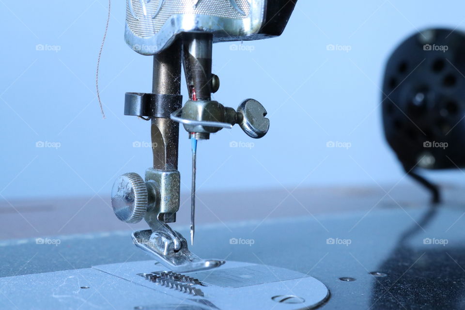 Antique belt driven sewing machine needle and thread