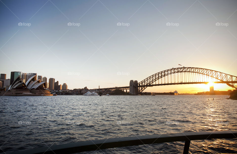 Sunset view of the Harbor Bridge and Sydney Opera House from a ferry from Taronga going back to Circulay Quay