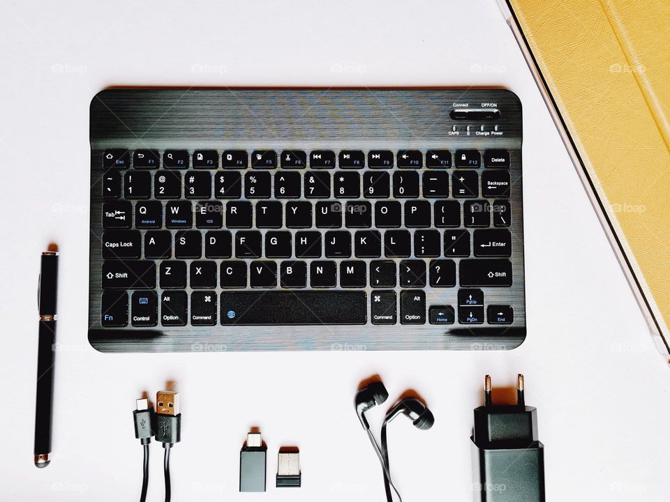 office desk with keyboard tablet and various accessories