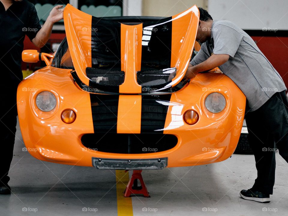 A sports car under maintenance in a garage