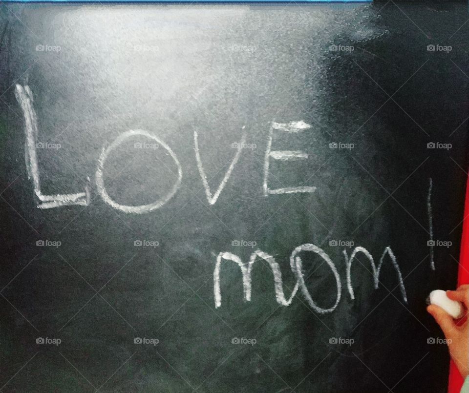 Lettering made by child's hand in chalk on a blackboard