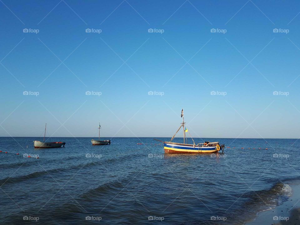 Three boats at the sea