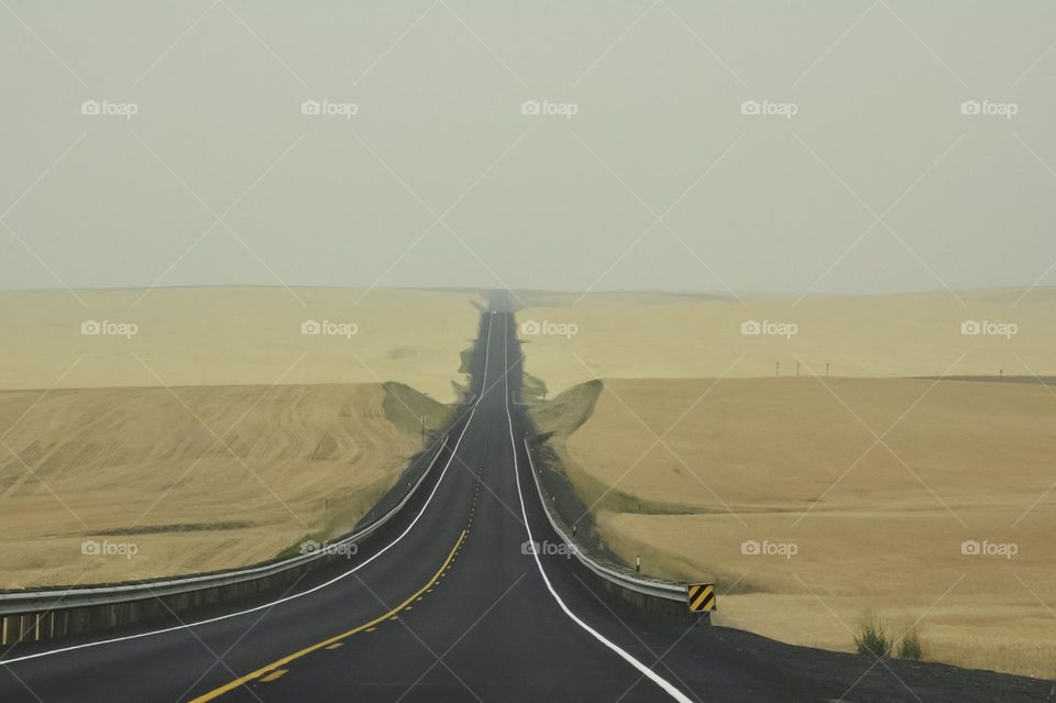 Highway through dry fields