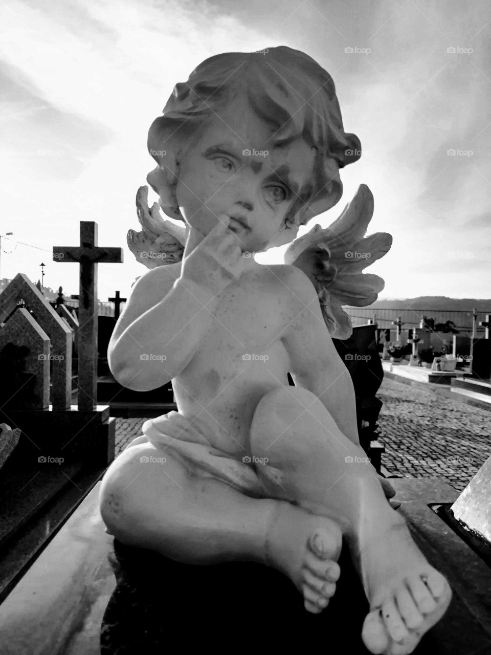 Black and white photograph of a stone angel in the cemetery