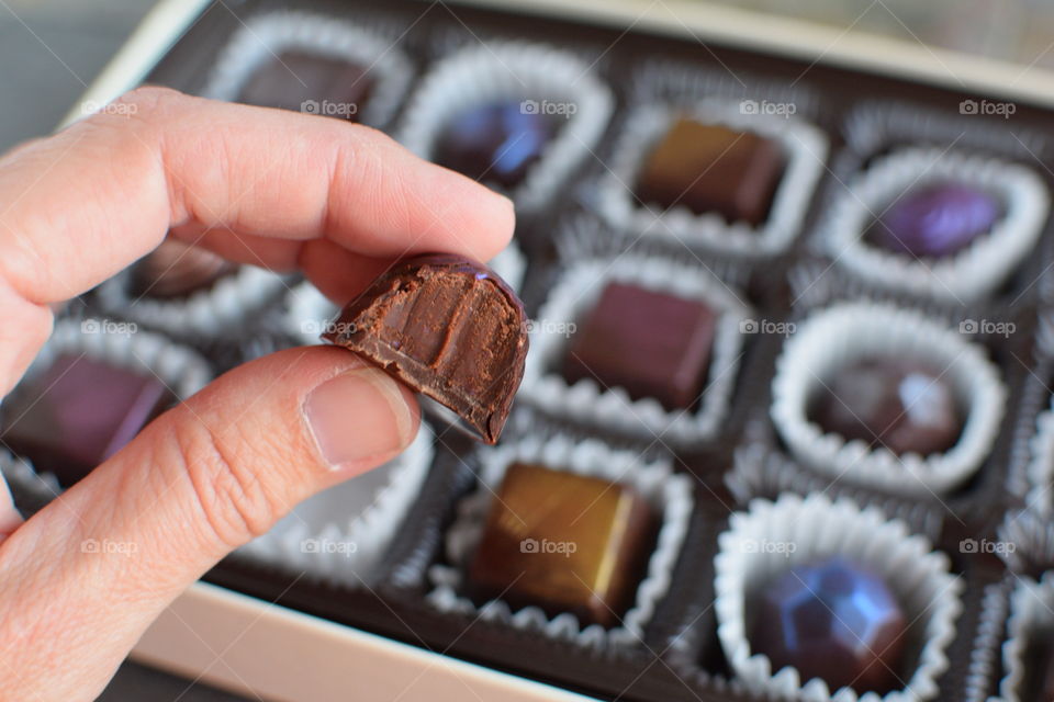 Close-up of eaten chocolate in hand
