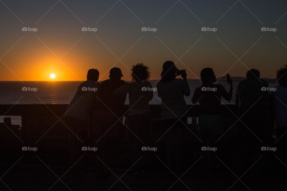 Group of people enjoying a nice sunset 