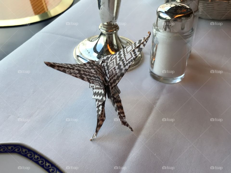 An origami pegasus resting in a cruise ship dining room. 
