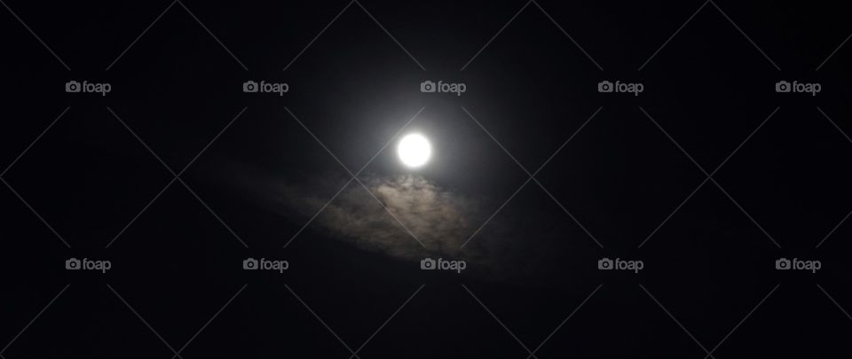 night photography. moon. clouds. sky. looking up at the moon and clouds in the night sky.