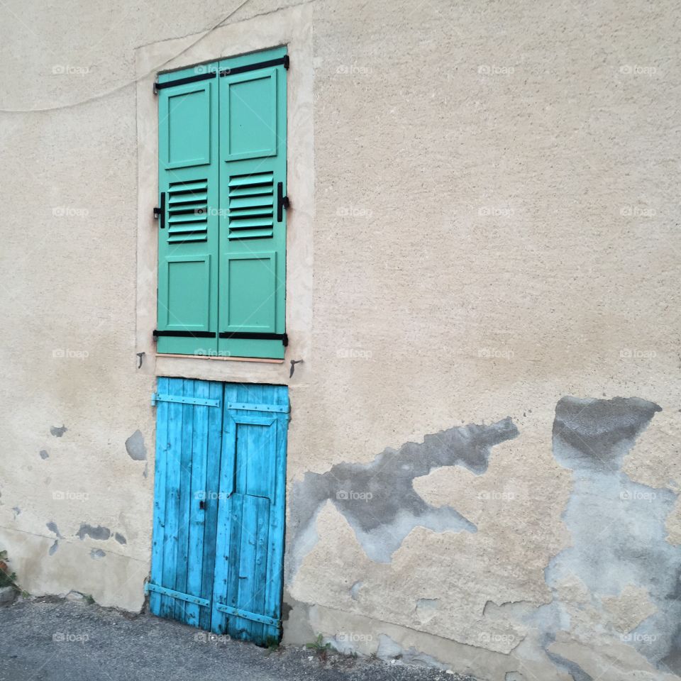 Blue and green Windows and doors in Moustier Sainte Marie Provence 