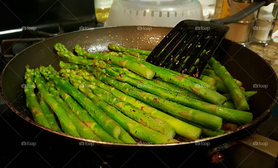 Cooking stir fried buttered garlic asparagus