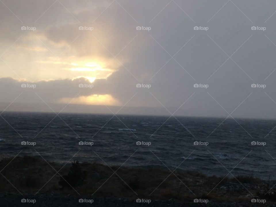 Sunset over stormy ocean