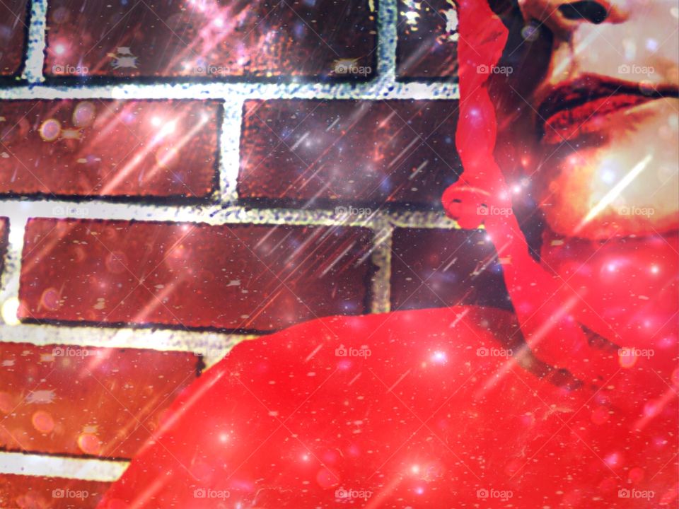 Woman in a red rain jacket facing a Spring rain.