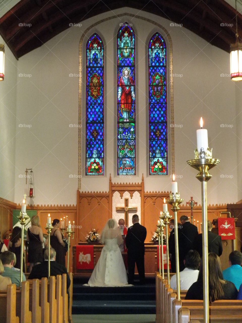 Traditional church wedding with beautiful stained glass windows. 