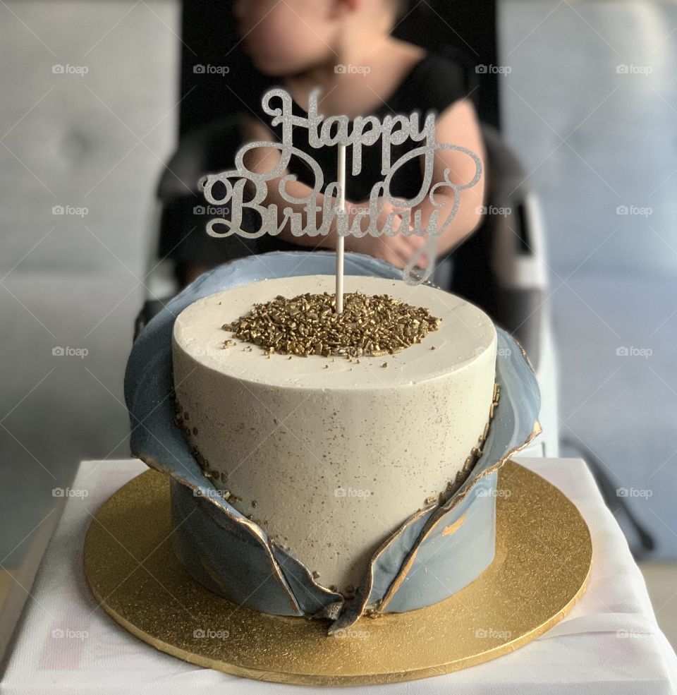 Happy birthday cake simple classy pretty with toddler boy behind 