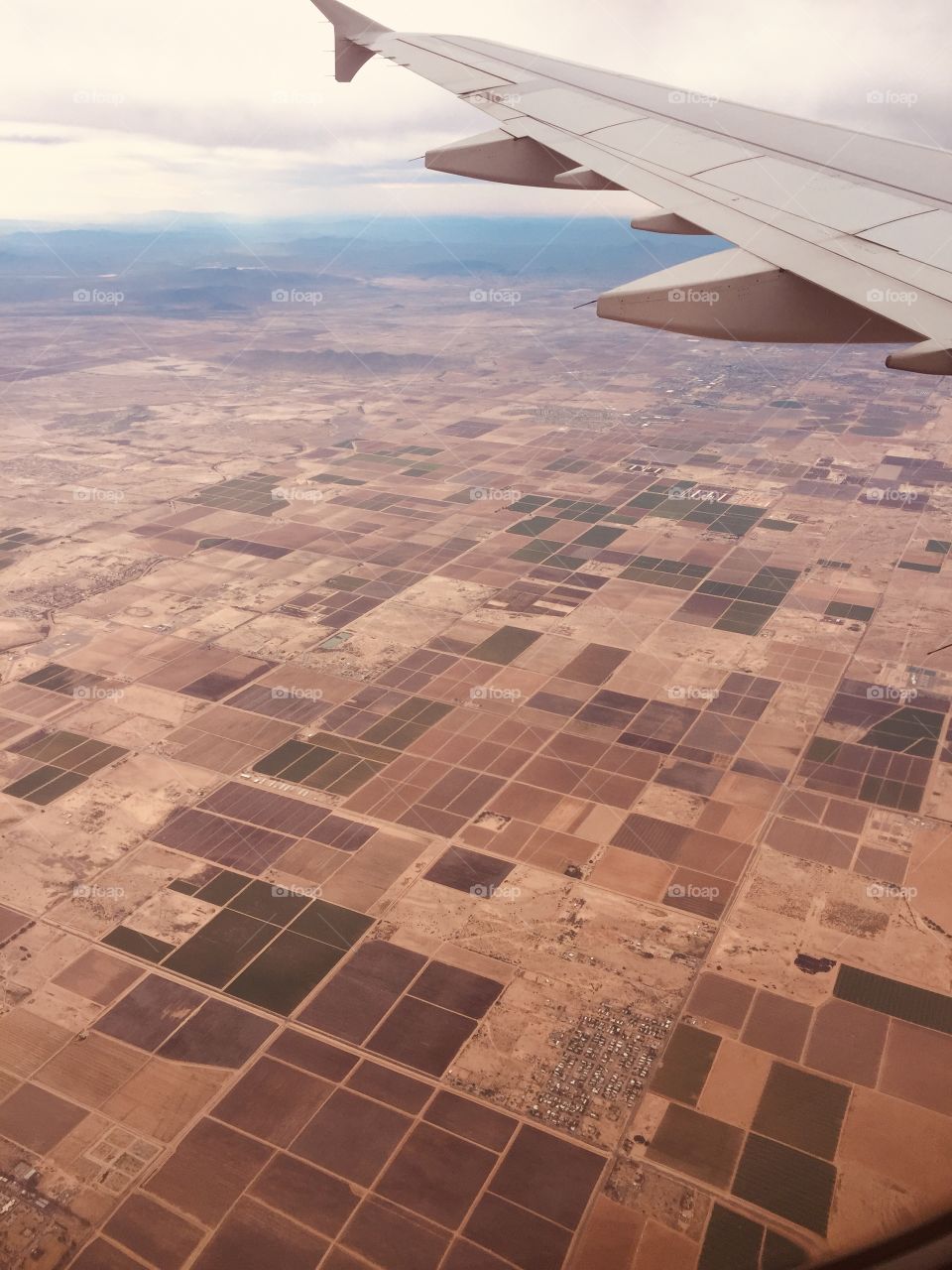View from airplane window of Arizona patches of arid desert landscape 
