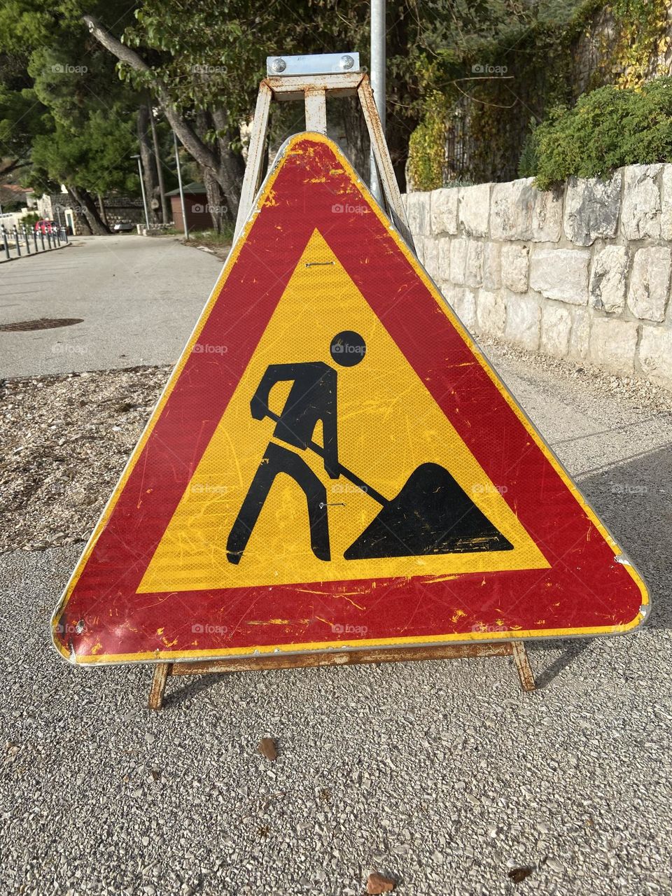 Red and yellow men at work sign.