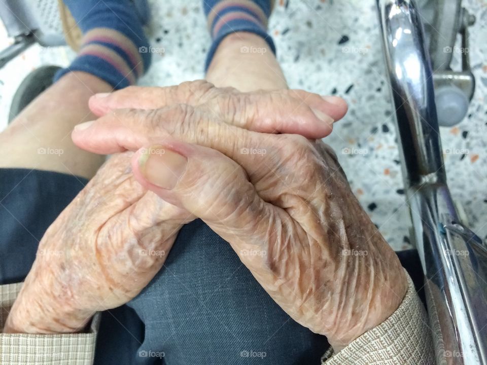 Aging woman hand on knee